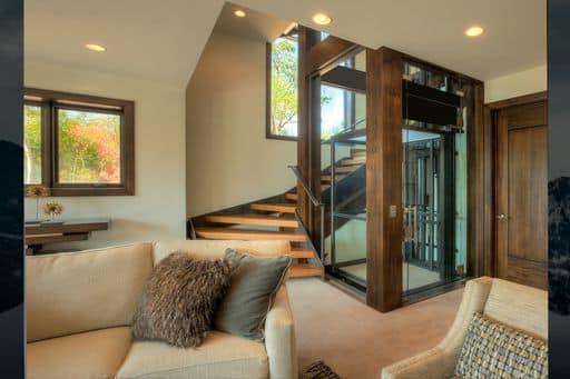 Glass elevator in luxury home from living area.